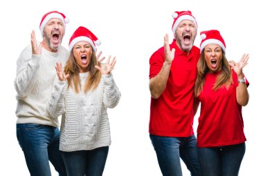 Kolaj bir orta yaş olgun güzel çift beyaz izole arka plan çılgın ve kızgın bağırarak ve agresif ifade ve silah kaldırdı bağırmaya üzerinde Noel şapka giyiyor. Hayal kırıklığı kavramı.