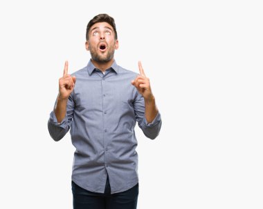 Yakışıklı delikanlı izole arka plan üzerinden hayran ve yukarıya bakıp parmakları ile işaret şaşırttı ve silah kaldırdı.