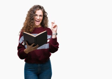 Genç esmer kız üzerinde gözlük takan bir kitap okuma arka plan bir fikir ya da soru işaret parmağı ile mutlu yüz sürpriz izole, number one