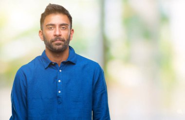 Yüzünde ciddi bir ifade ile izole arka plan yetişkin İspanyol adam. Basit ve doğal kameraya bakıyor.