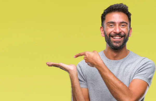 Adult Hispanic Man Isolated Background Amazed Smiling Camera While Presenting — Stock Photo, Image