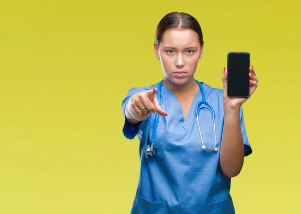 Young Caucasian Doctor Woman Showing Smarpthone Isolated Background Pointing Finger — Stock Photo, Image