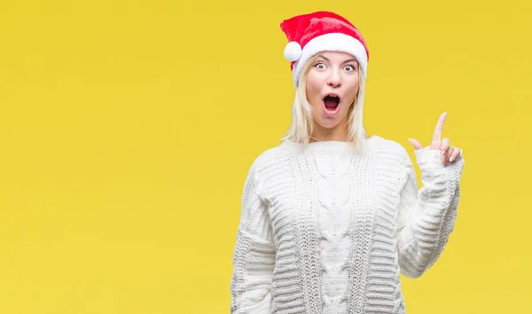 이상의 크리스마스 모자를 금발의 성공적인 아이디어와 손가락 가리키는 — 스톡 사진