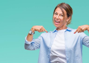 Orta yaş yüzünde gülümseme ile kendinden emin görünüyorsun, kendini gururlu ve mutlu parmakları ile işaret izole arka plan üzerine İspanyol kadın kıdemli.