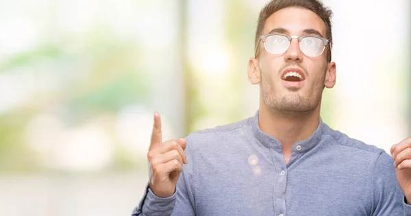 Handsome Young Elegant Man Wearing Glasses Amazed Surprised Looking Pointing — Stock Photo, Image