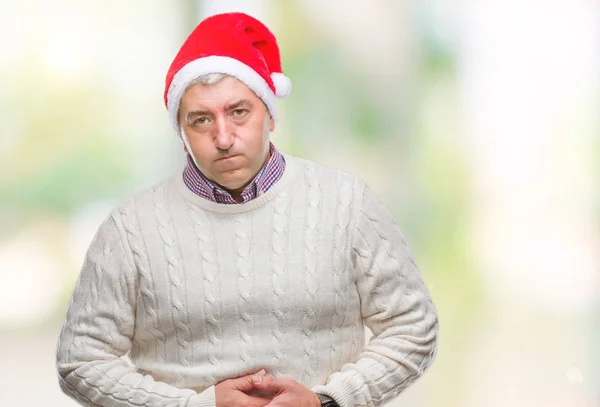 英俊的老人戴着圣诞节帽在孤立的背景与手在胃因为消化不良 痛苦的疾病感觉不适 疼痛概念 — 图库照片