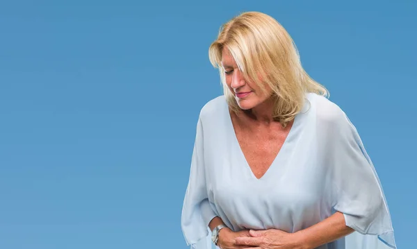 Middle age blonde business woman over isolated background with hand on stomach because indigestion, painful illness feeling unwell. Ache concept.