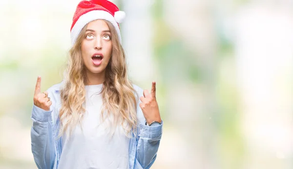 Hermosa Joven Rubia Con Sombrero Navidad Sobre Fondo Aislado Asombrada —  Fotos de Stock