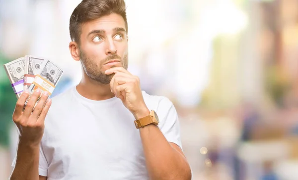 Joven Hombre Guapo Sosteniendo Pila Dólares Sobre Fondo Aislado Cara — Foto de Stock