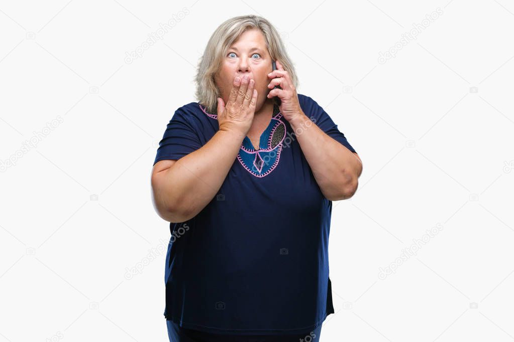 Senior plus size caucasian woman talking on the phone over isolated background cover mouth with hand shocked with shame for mistake, expression of fear, scared in silence, secret concept