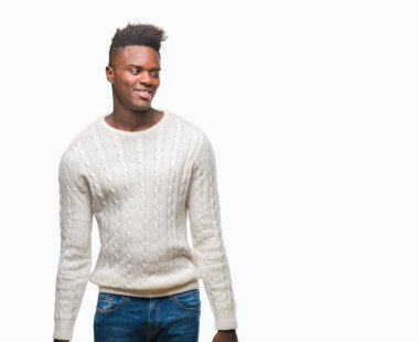 Afrikalı-Amerikalı genç uzak tarafına yüzünde, doğal ifade gülümseme ile seyir izole arka plan üzerinde. Kendine güvenen gülüyor.