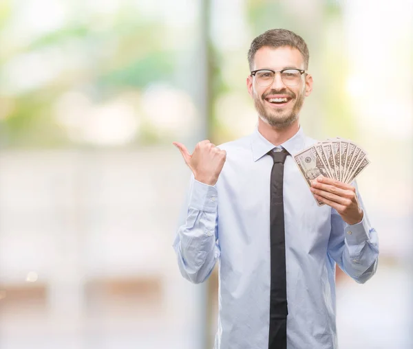 Young Hipster Business Man Holding Dollars Pointing Showing Thumb Side — Stock Photo, Image
