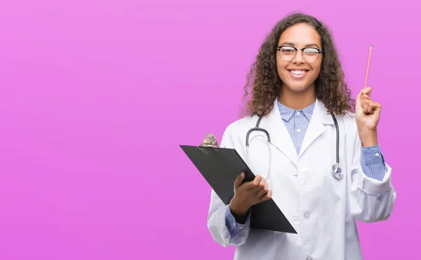 Young Hispanic Doctor Woman Holding Clipboard Surprised Idea Question Pointing — Stock Photo, Image