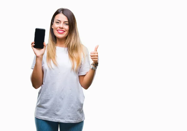 年轻美丽的女人显示空白屏幕上的智能手机在孤立的背景快乐与大微笑做 拇指与手指 优秀的标志 — 图库照片