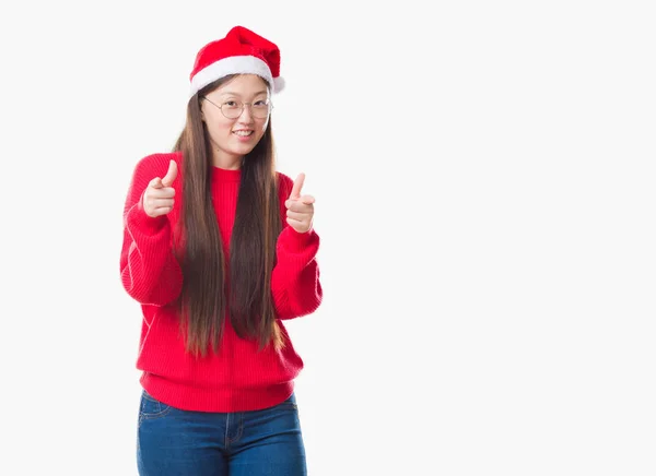 年轻的中国妇女在孤立的背景戴着圣诞节帽子指向相机与快乐和滑稽的脸 良好的能量和共鸣 — 图库照片