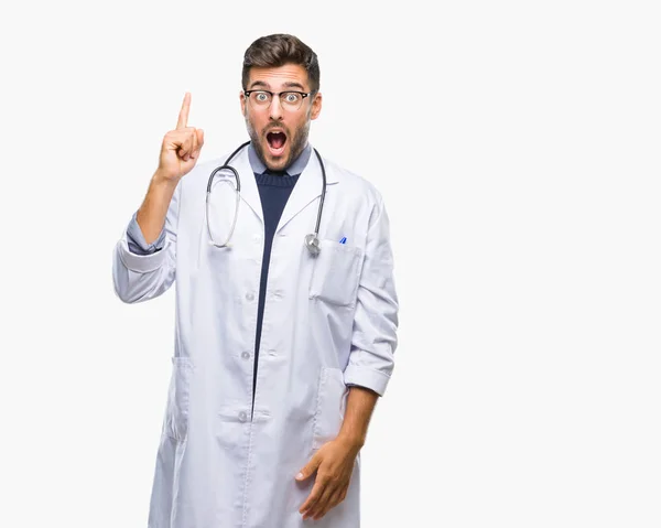 Junger Gutaussehender Arzt Mit Isoliertem Hintergrund Mit Erhobenem Zeigefinger Und — Stockfoto