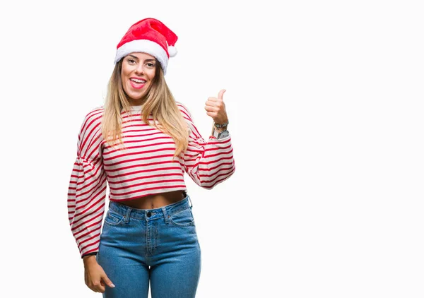 若くてきれいな女性見て 親指側に上向きの幸せそうな顔を浮かべて隔離された背景にクリスマスの帽子をかぶって — ストック写真