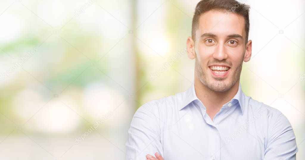 Handsome young businessman happy face smiling with crossed arms looking at the camera. Positive person.
