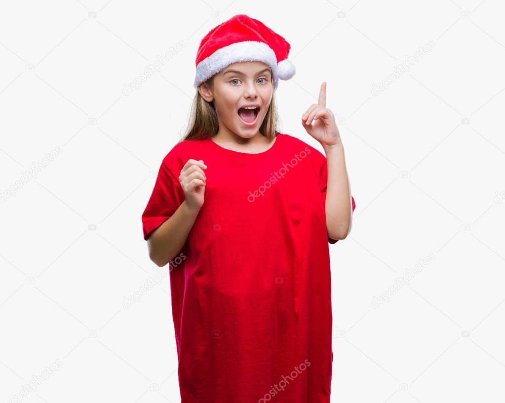 Young beautiful girl wearing christmas hat over isolated background pointing finger up with successful idea. Exited and happy. Number one.