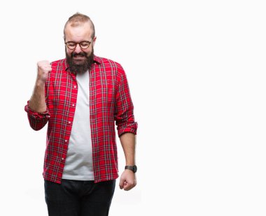 İzole arka kolları olan başarı için heyecan üzerinde gözlük takan Genç beyaz hipster adam zafer kutluyor gülümseyen kaldırdı. Kazanan kavramı.