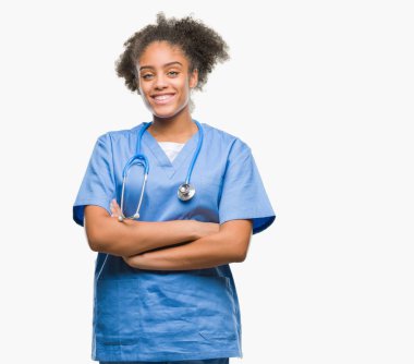 İzole arka plan mutlu yüz çapraz silah kameraya bakarak ile gülümseyen genç afro Amerikalı doktor kadın. Olumlu bir kişi.