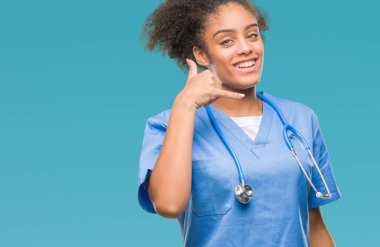 Genç afro Amerikalı doktor kadın yapıyor gülümseyen izole arka plan üzerinde telefon hareketi ile el ve parmak telefonda konuşuyor gibi. Kavramları iletişim.