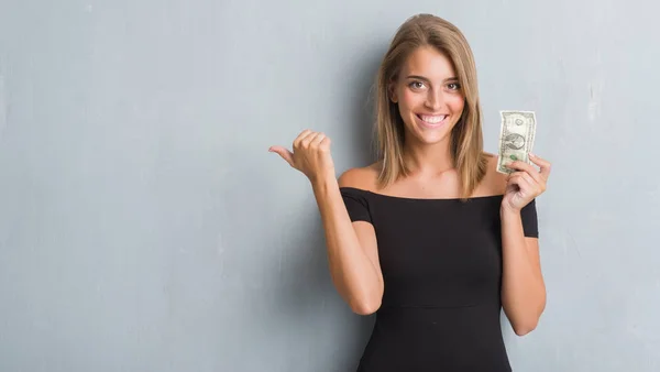 Beautiful Young Woman Grunge Grey Wall Holding Dollar Pointing Showing — Stock Photo, Image