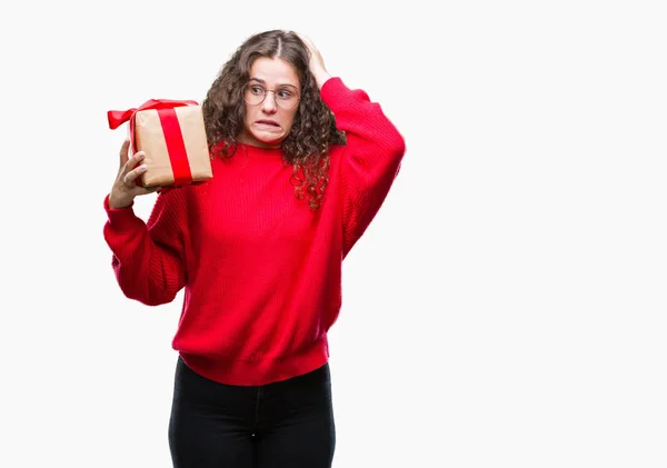 Young Brunette Girl Holding Gift Isolated Background Stressed Hand Head — Stock Photo, Image