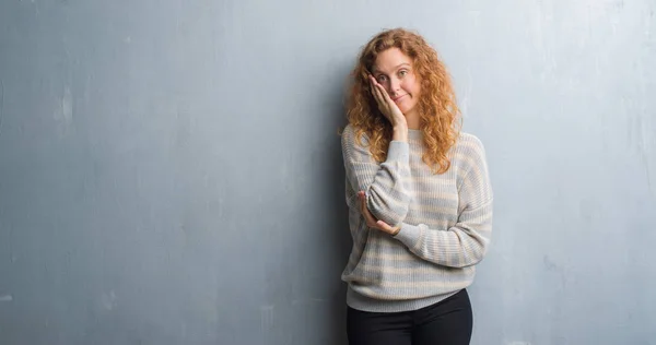 灰色のグランジ壁考えて見ると疲れや退屈組んだ腕を持つうつ病問題に若い赤毛の女性 — ストック写真