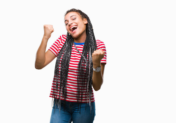 Young braided hair african american girl over isolated background very happy and excited doing winner gesture with arms raised, smiling and screaming for success. Celebration concept.