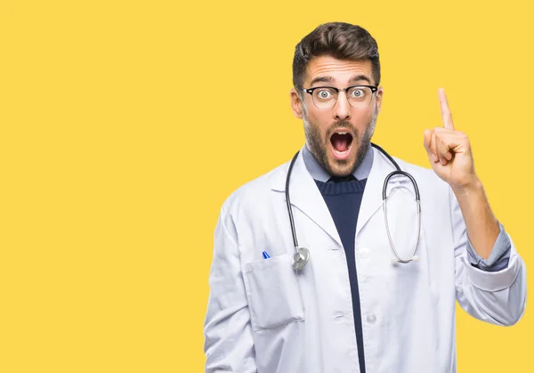 Junger Gutaussehender Arzt Mit Isoliertem Hintergrund Mit Erhobenem Zeigefinger Und — Stockfoto