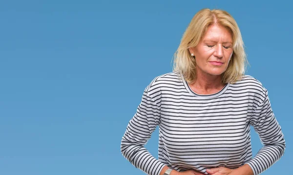 Middle age blonde woman over isolated background with hand on stomach because indigestion, painful illness feeling unwell. Ache concept.