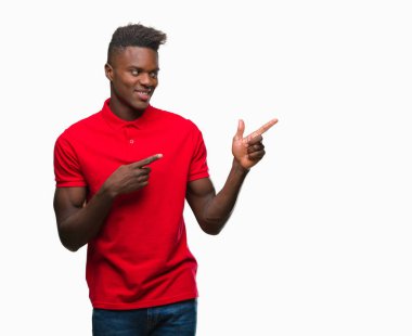 Gülümseyen ve iki elleri ve parmakları ile tarafına işaret kamera bakarak izole arka plan üzerinde genç Afro-Amerikan adam.