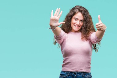 Gösterilen ve parmakları ile işaret izole arka plan üzerinde pembe kazak giyen güzel esmer kıvırcık saçlı Genç kız kendinden emin ve mutlu gülümseyerek süre 6 numara.