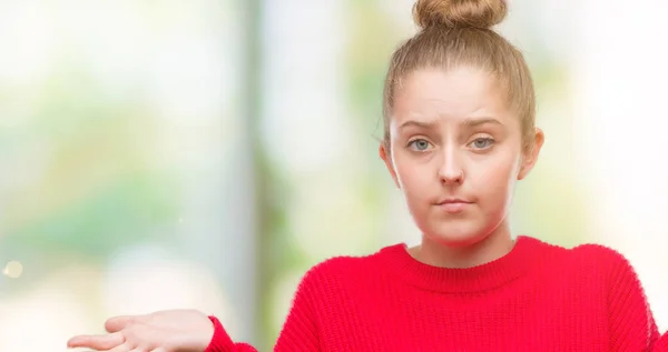 Young Blonde Woman Wearing Bun Red Sweater Clueless Confused Expression — Stock Photo, Image