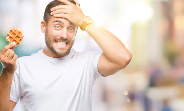 Young Handsome Man Eating Sweet Waffle Isolated Background Stressed Hand — Stock Photo, Image