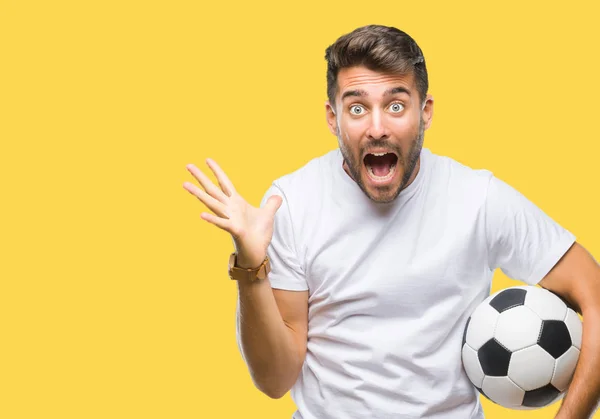 Jovem Homem Bonito Segurando Bola Futebol Sobre Fundo Isolado Muito — Fotografia de Stock