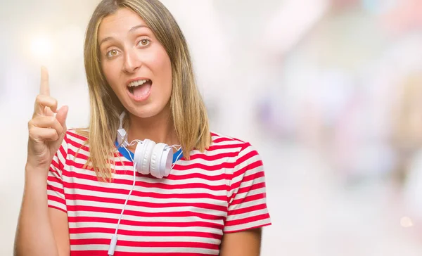 Mooie Jongedame Luisteren Muziek Hoofdtelefoon Dragen Geïsoleerde Achtergrond Wijzende Vinger — Stockfoto