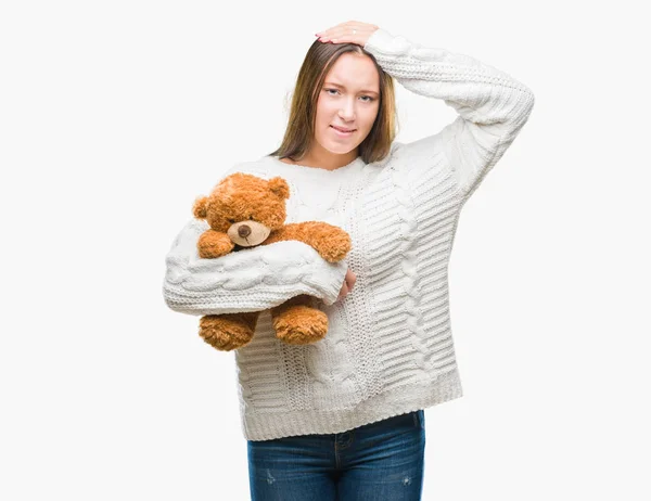 Mujer Caucásica Joven Sosteniendo Osito Peluche Sobre Fondo Aislado Estresado —  Fotos de Stock