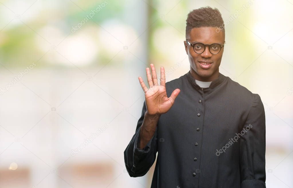 Young african american priest man over isolated background showing and pointing up with fingers number five while smiling confident and happy.