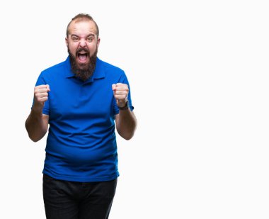 İzole arka plan kutlama üzerinde giyen mavi gömlek şaşırttı ve silah ile başarı için hayran Genç beyaz hipster adam kaldırdı ve gözleri açık. Kazanan kavramı.