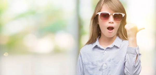 幸せそうな顔を笑顔で手と指を上向き青いシャツを着た若い金髪の幼児 — ストック写真