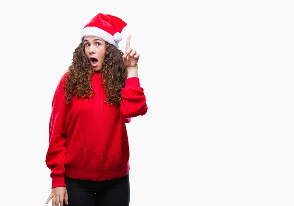 Chica Morena Joven Con Sombrero Navidad Sobre Fondo Aislado Señalando — Foto de Stock