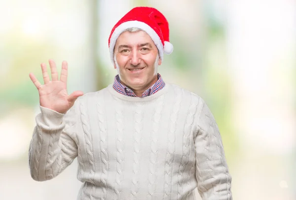 英俊的老人戴着圣诞节帽子在孤立的背景显示和指向与手指数字五同时微笑自信和快乐 — 图库照片