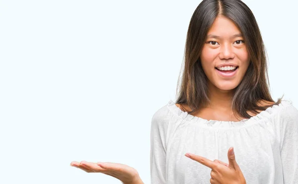 Young Asian Woman Isolated Background Amazed Smiling Camera While Presenting — Stock Photo, Image