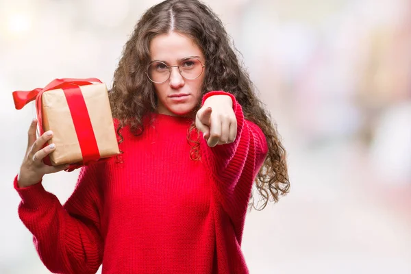 Young Brunette Girl Holding Gift Isolated Background Pointing Finger Camera — Stock Photo, Image