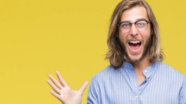 Genç yakışıklı adam uzun saçlı gözlüklü üzerinde arka plan çılgın kutlama izole ve silah ile başarı için yükseltilmiş ve açık gözleri heyecanlı çığlık hayrete düşürdü. Kazanan kavramı