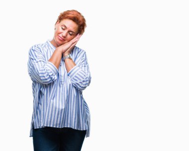 Uyku yorgun hayal ve ellerle birlikte poz ile kapalı gözler gülümseyen izole arka plan Atrractive üst düzey beyaz Kızıl saçlı kadın.