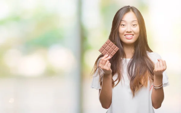 Young Asian Woman Eating Chocolate Bar Isolated Background — Stock Photo, Image