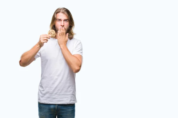 Young Handsome Man Long Hair Eating Chocolate Cooky Isolated Background — Stock Photo, Image